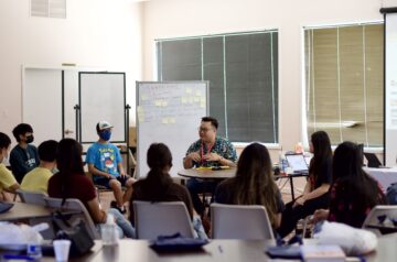 person speaks to a classroom of youth