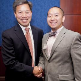 Two men in suits shaking hands 