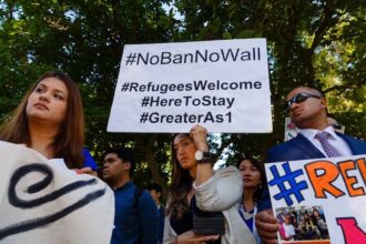 A sign that says #NoBanNoWall and #RefugeesWelcome