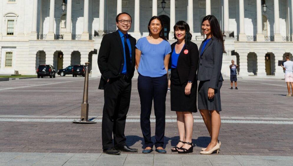 Four individuals including blog author Cheryl Yin stand in front of a building