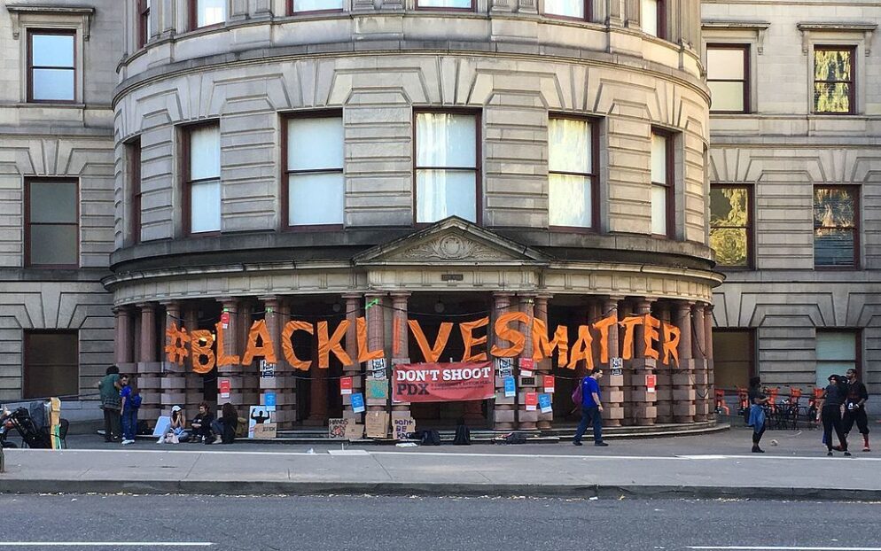 Activists holding signs in solidarity with the Black Lives Matter movement.