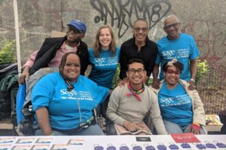 SEARAC staff member Jenna McDavid (back row, second from left) tabling with SAGE staff and volunteers at Harlem Pride in 2018.