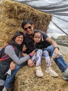 Family in front of haystack