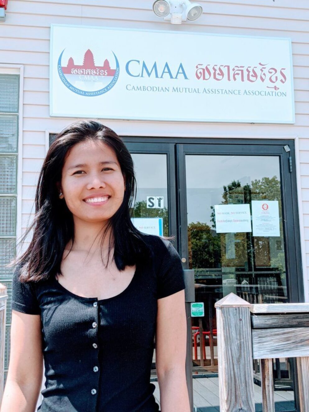 Leakhena standing in front of the Cambodian Mutton Assistance Association's office.