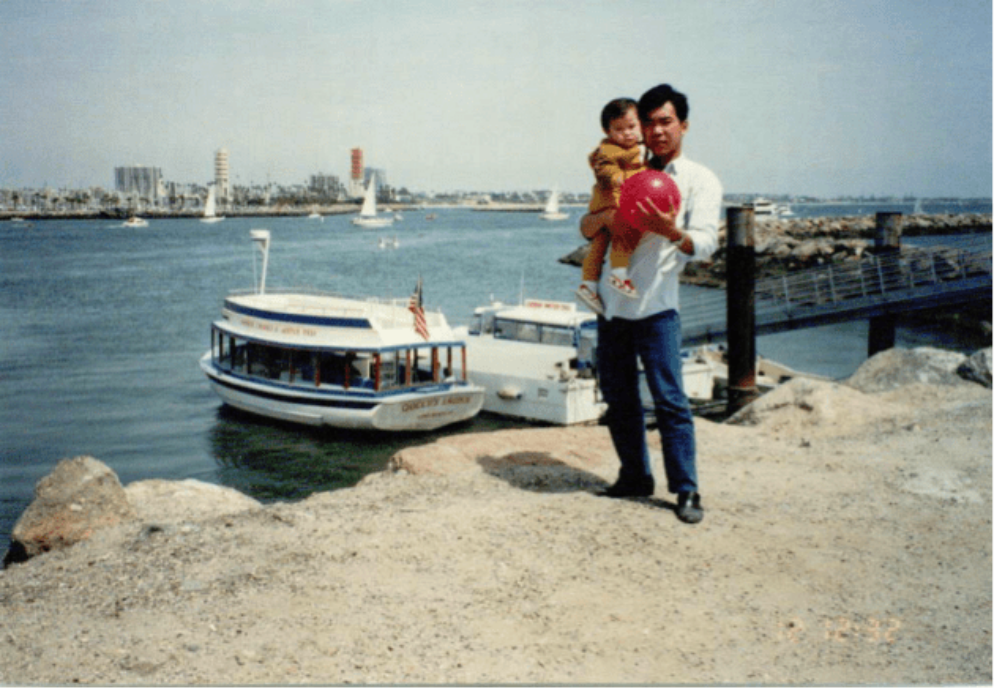 Baby Mandy being held by her father at a bay.