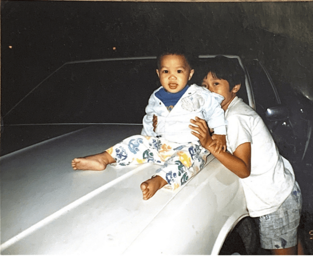 Baby Ocean sitting on a white vehicle.