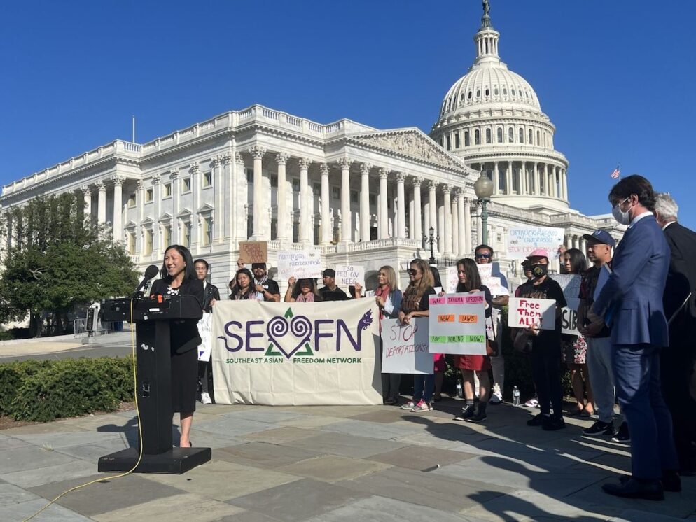 Group of people gather behind a speaker at the SEADRA press conference