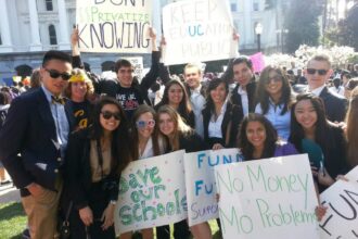 Advocates holding posters to fund public education.