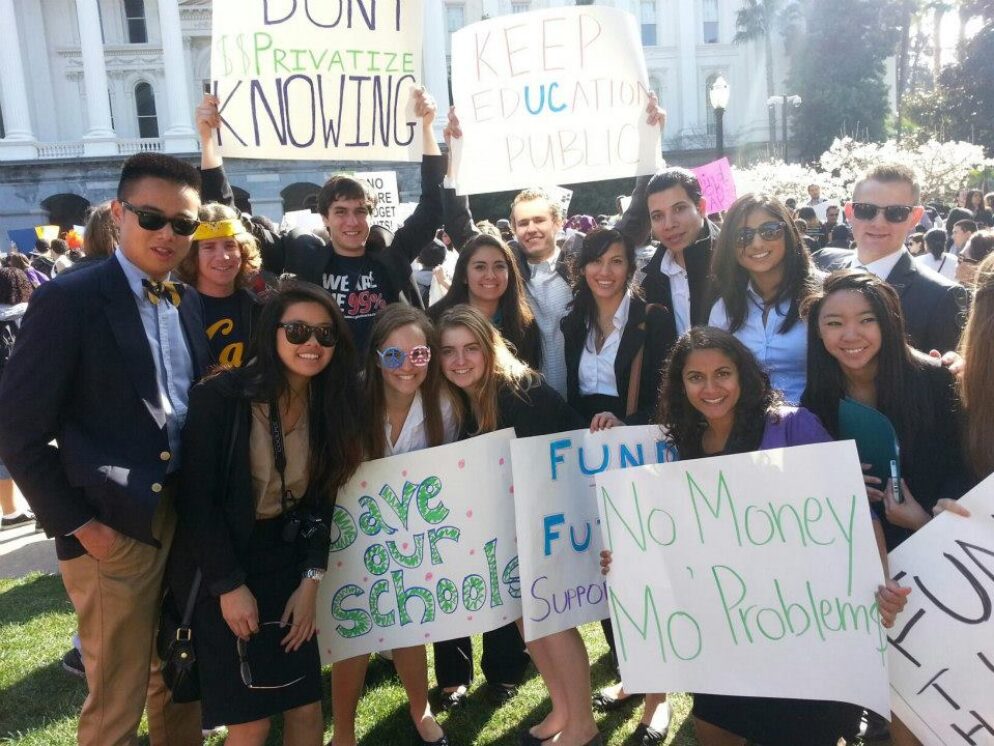 Advocates holding posters to fund public education.