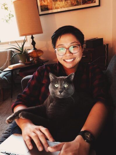 Tamthy smiling with her cat.