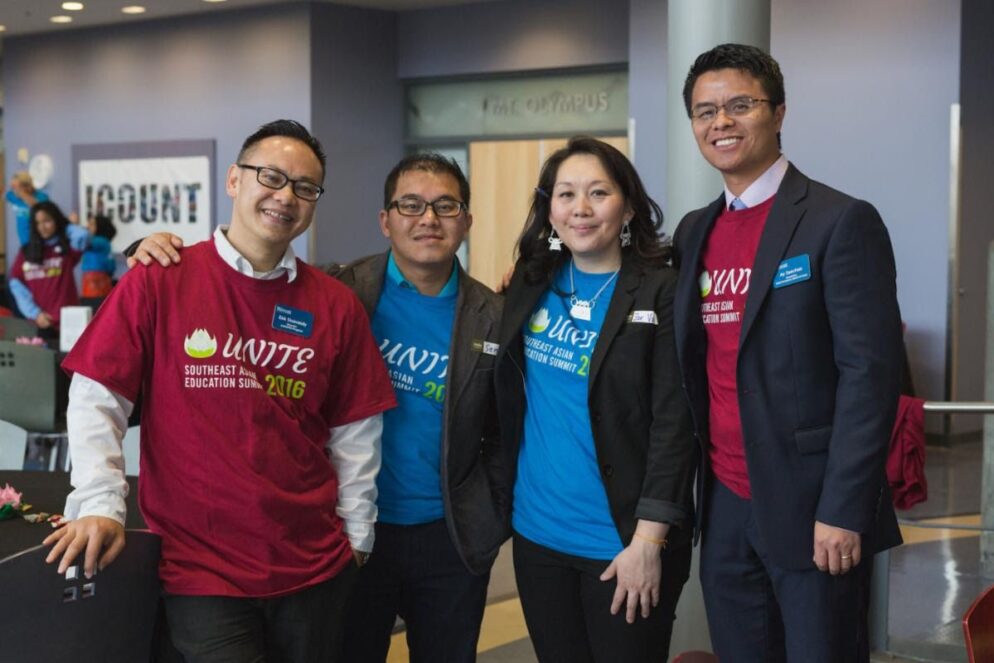 A group of people wearing red and blue t-shirt that reads 'Unite.'