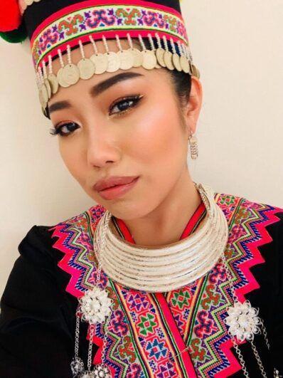 A person wears traditional Hmong attire