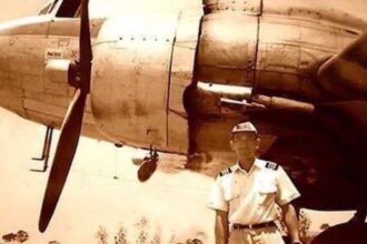 A man in front of a plane.