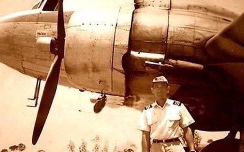 A man in front of a plane.