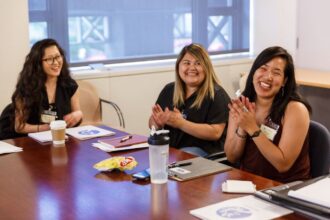 Women smiling at a table.