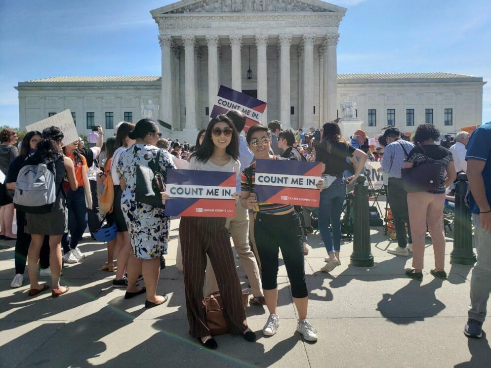 Two people holding up signs that say 