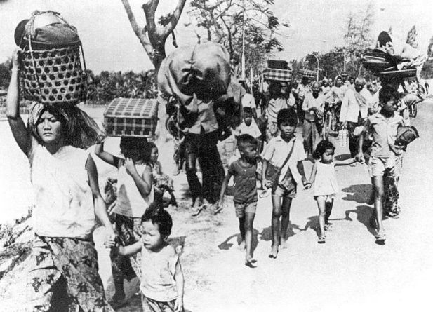 Children holding hands and walking forward.