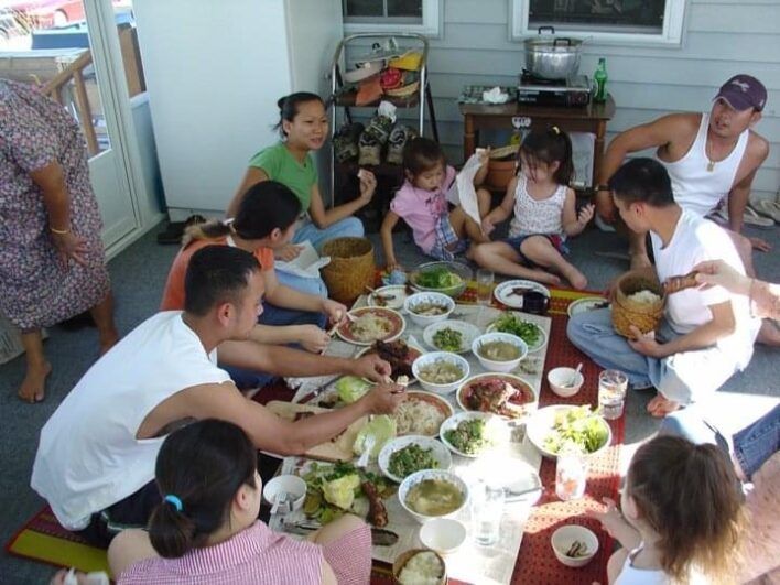 Jazmin and her family enjoying a spread of Lao food together.