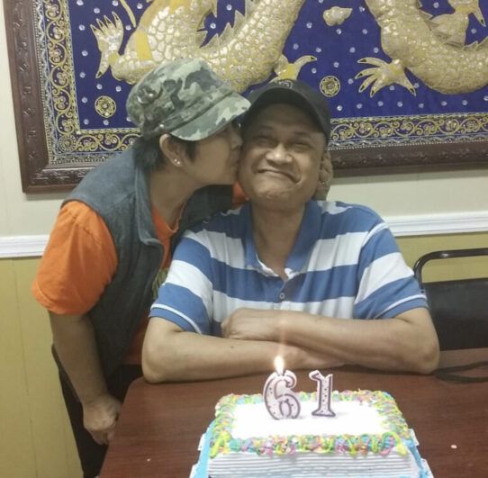 A couple with a birthday cake.