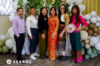 SEARAC and FIRM staffs standing in front of a backdrop.