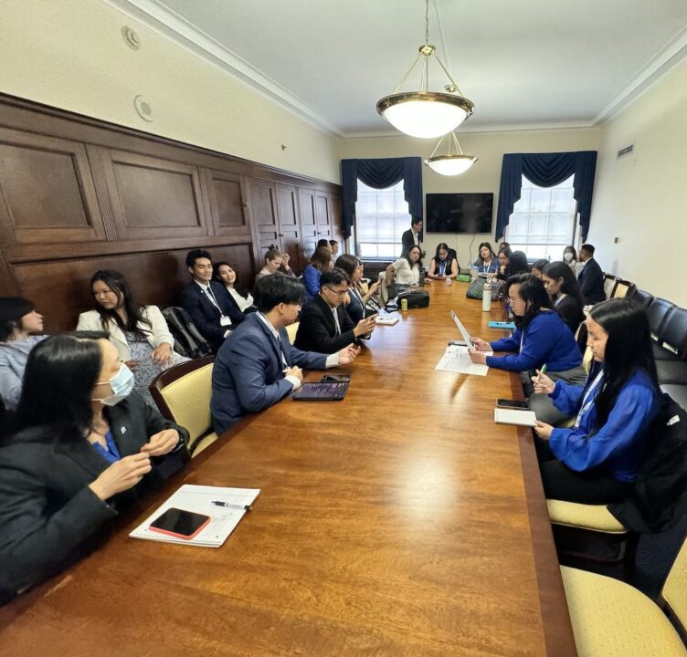 People sit around a conference table