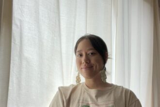 A woman sitting by the window.