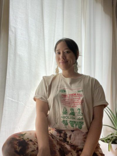 A woman sitting by the window.