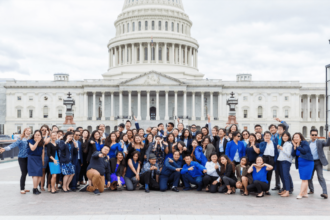 group poses in front of Capitol Building