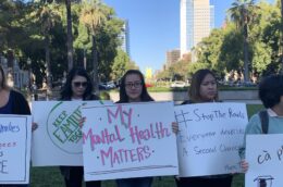 Person holds sign saying My Mental Health Matters