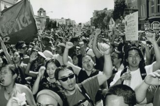 A black and white image of people protesting for social justice