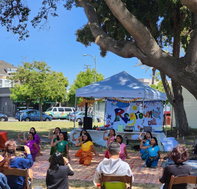 A group of people perform outdoors