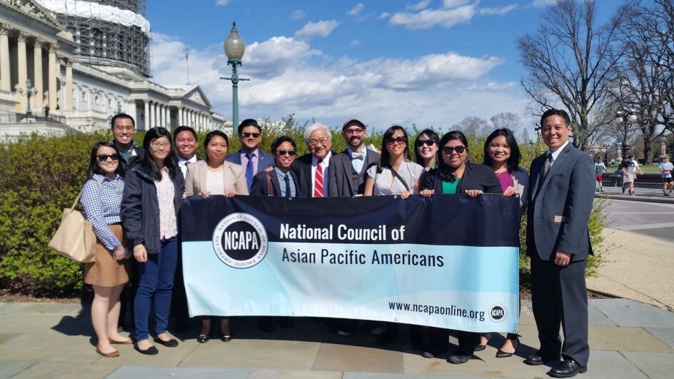 A group of people hold an NCAPA sign