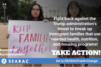 An image of two young people holding a sign that says Keep Families Together