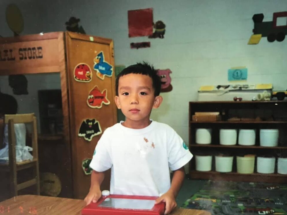 A child holding a doodle board