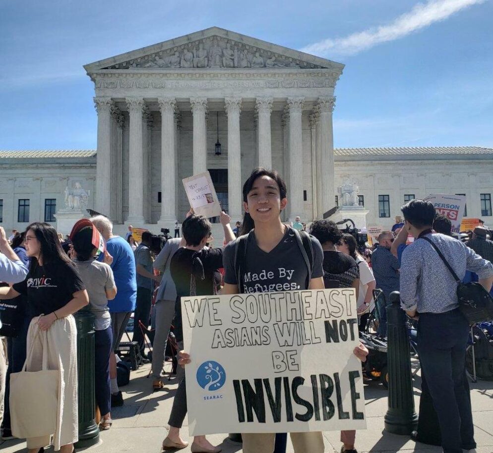 A young person standing on the steps of the Supreme Court building