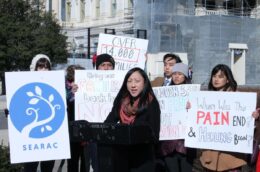 People hold signs against deportation