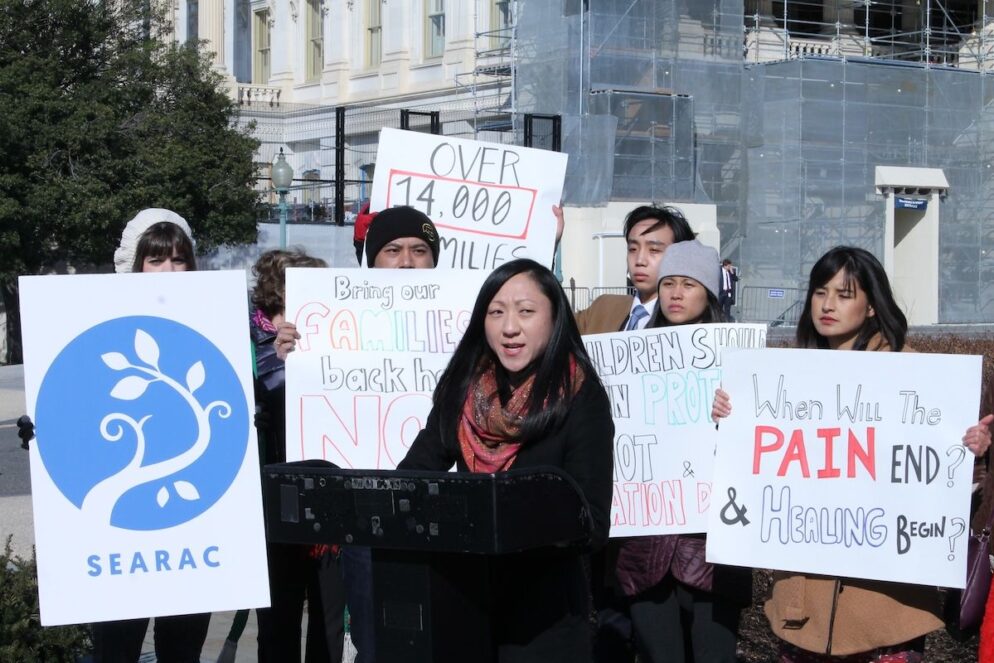 People hold signs against deportation