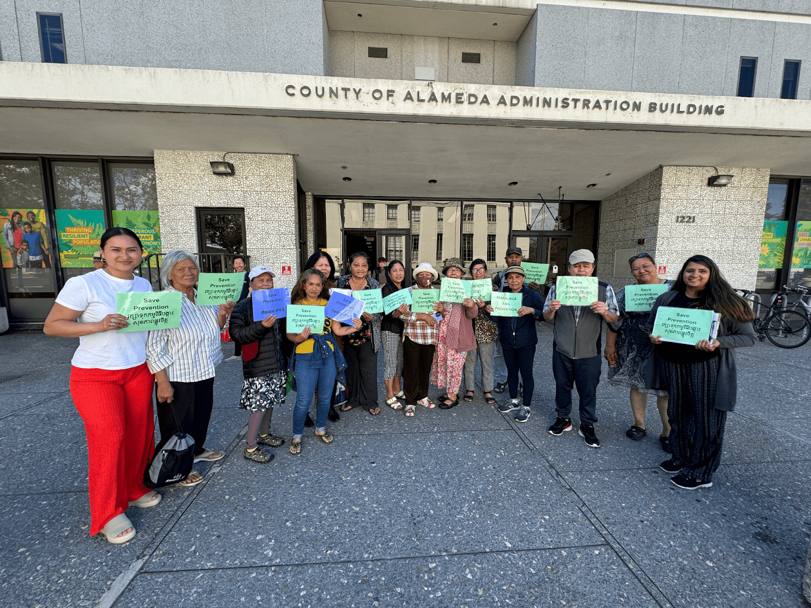 A group of young people and elders at an administrative building. 