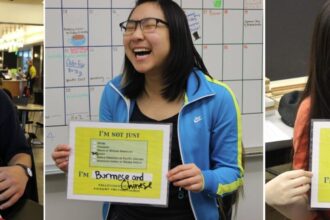 Students from North Seattle Community College pose with signs in support of the All Students Count Act.