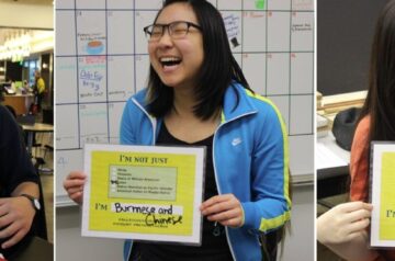 Students from North Seattle Community College pose with signs in support of the All Students Count Act.