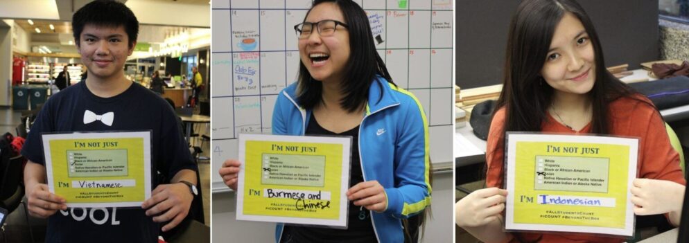 Students from North Seattle Community College pose with signs in support of the All Students Count Act.