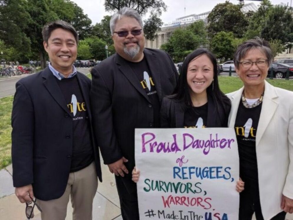 Quyen holding a sign showing her proudness of her identities.