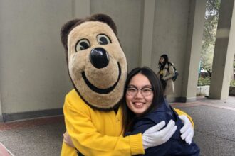 Tiffany hugging a mascot.