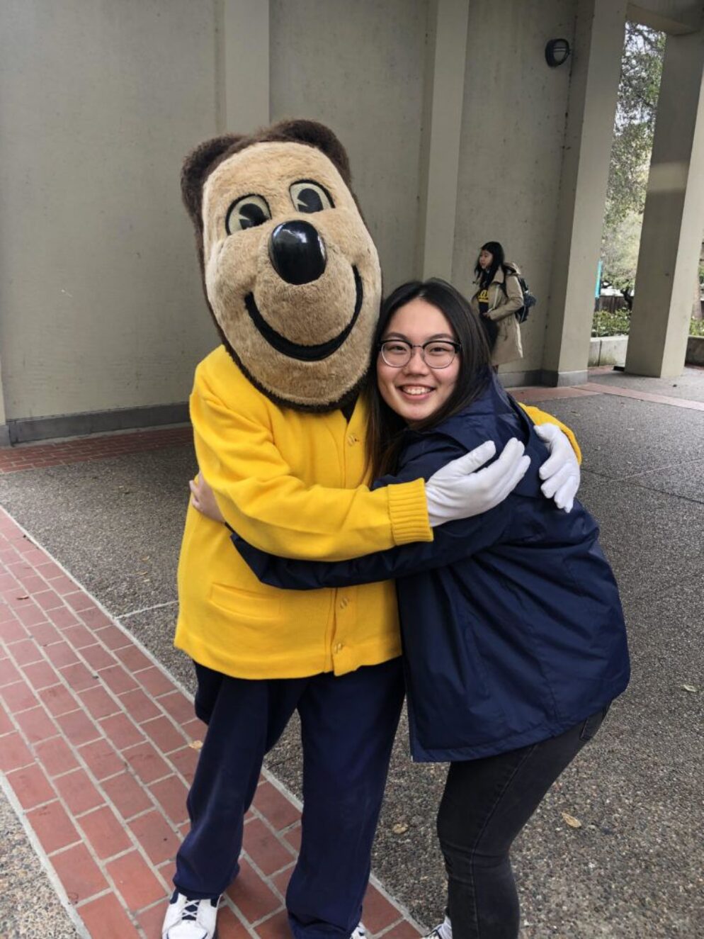 Tiffany hugging a mascot.