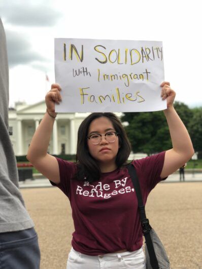 Person wearing Made by Refugees shirt