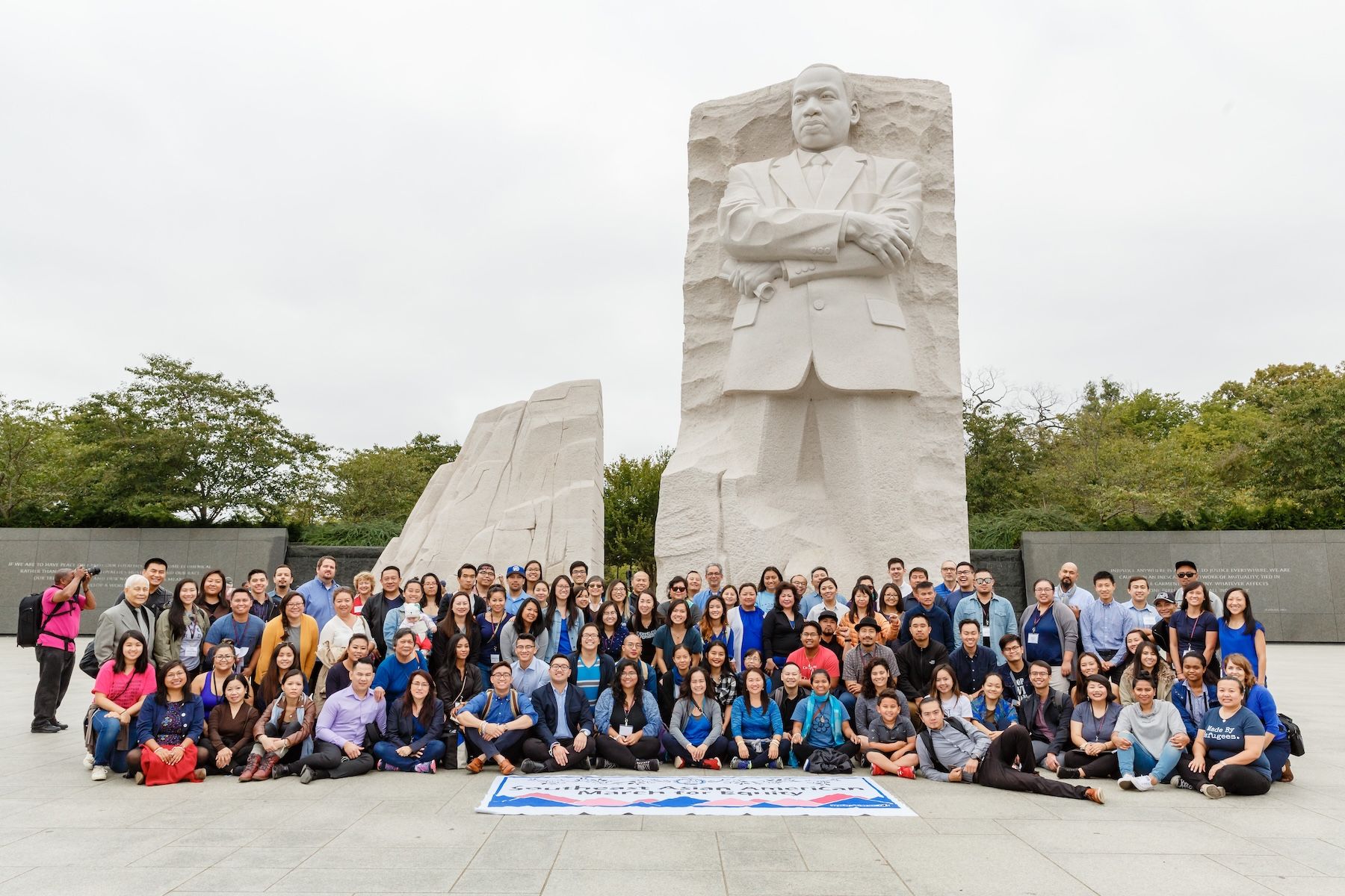 large group of individuals pose in front of MLK Memorial in DC