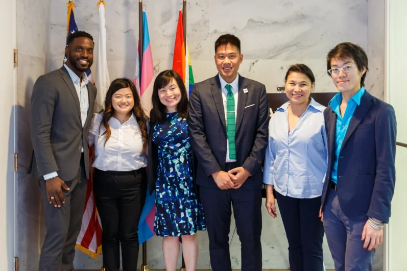 group of individuals pose in a hallway
