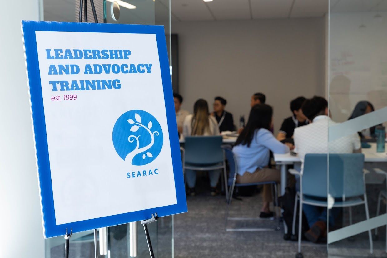 A sign with a SEARAC logo in front of a room