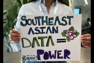 person holds a poster that says Southeast Asian Data = Power