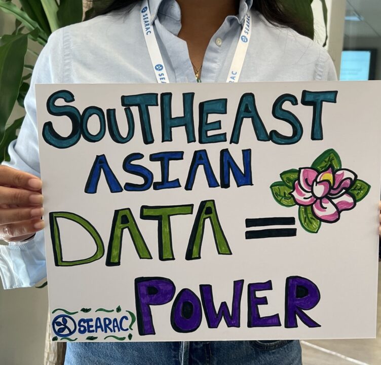 person holds a poster that says Southeast Asian Data = Power